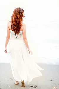 woman standing near seashore looking on calm sea thumbnail