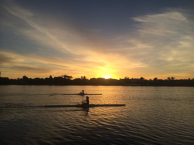 silhouette of person riding on boats thumbnail
