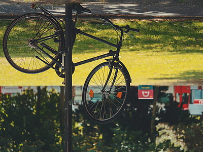 flipped black mountain bike near grass field thumbnail