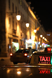 selective-focus photography of Taxi Lisboa during night thumbnail