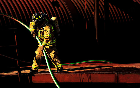 fireman holding green hose thumbnail