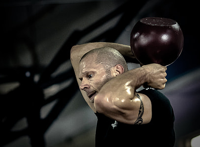 man wearing black shirt holding red ball on back thumbnail