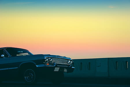 blue car under calm sky during golden hour thumbnail