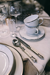 Fancy restaurant dinner table decorated with quail eggs and feathers thumbnail