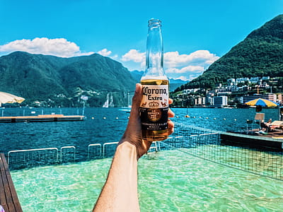 Person Holding Corona Extra Bottle thumbnail