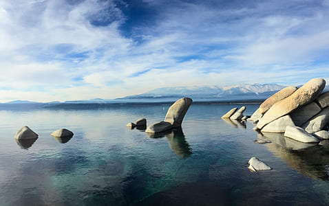 gray rock formation on body of water thumbnail