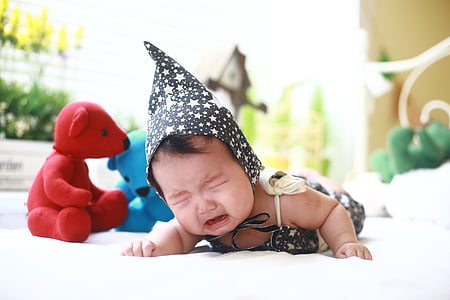 baby crawling on white surface while crying thumbnail