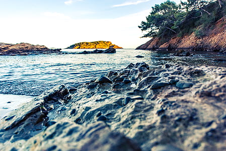 rock formation near body of water thumbnail