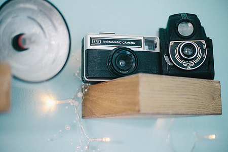 black and gray SLR camera on beige rack thumbnail