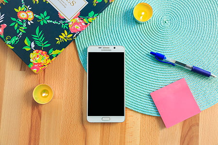 white Samsung smartphone on wooden surface thumbnail