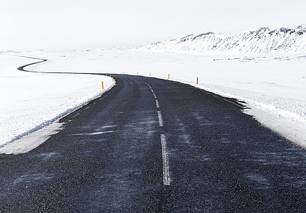 black asphalt road along snow at daytime thumbnail