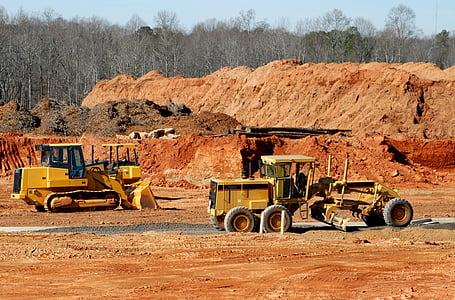 yellow grader and front loader on brown soil thumbnail