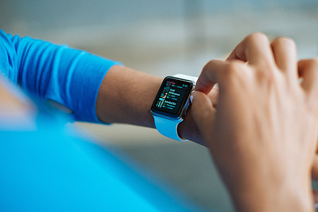 person using silver Apple Watch thumbnail