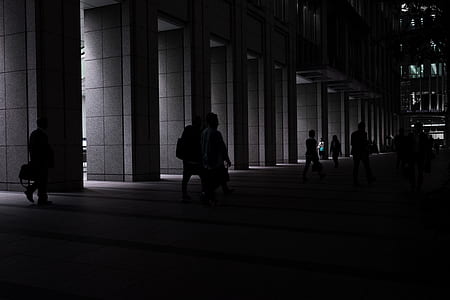 group of people walking near building at night time thumbnail