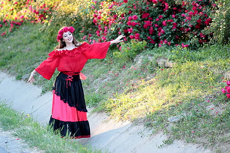woman wearing red flower tiara near pink petaled flower thumbnail
