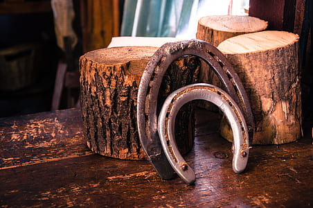 two gray metal horseshoe beside brown woods thumbnail