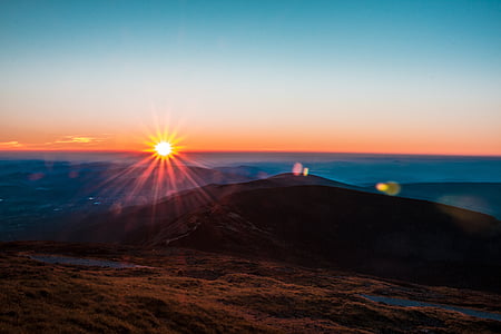 silhouette of hill during golden hour thumbnail