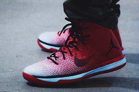 man wearing pair of red-white-and-black Air Jordan 31's thumbnail