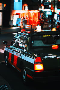 black and white sedan on road during nighttime thumbnail