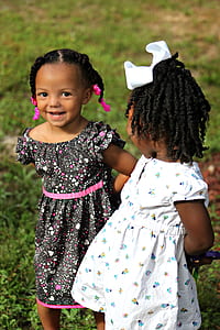 tilt shift lens photography of two black haired girl wearing white and black dresses thumbnail