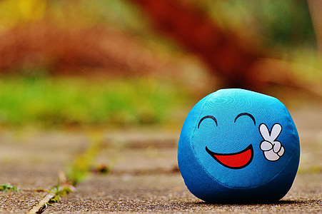 shallow focus photography of blue peace emoticon toy thumbnail