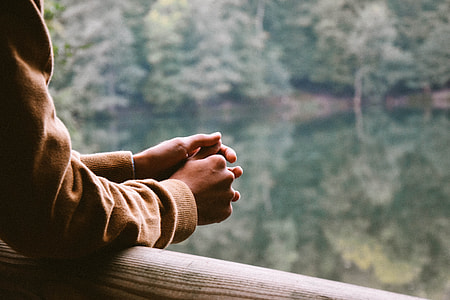 person leaning front on brown wooden bar thumbnail