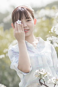 Woman Holding White Cherry Blossom Flower thumbnail