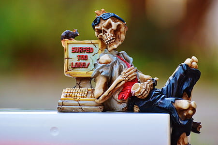 beige skeleton figurine on white surface thumbnail