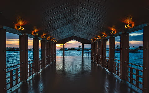 open wooden building surrounded with water thumbnail