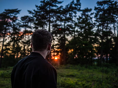 man in black top looking at the trees thumbnail
