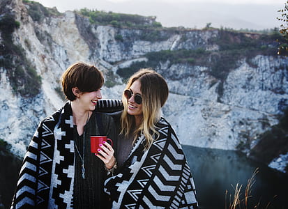 two woman sharing one blanket thumbnail