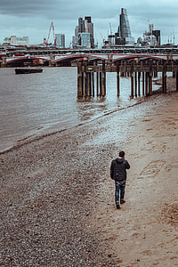 man walking on sea shore thumbnail