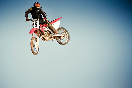 man riding in red dirt bike thumbnail