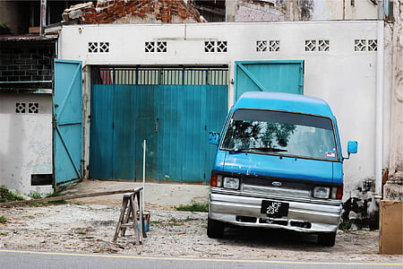 blue van parked in front of house thumbnail
