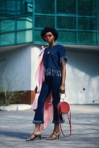 Shallow Focus Photography of Woman in Blue Clothes Holding Red Leather 2-way Handbag thumbnail