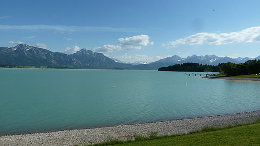 panoramic photography of calm body of water facing mountains during daytime thumbnail