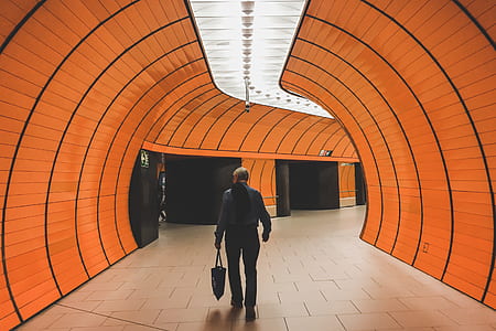 man walking in tunnel with lights thumbnail