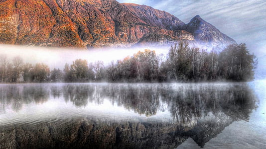calm lake near orange mountain during daytime thumbnail