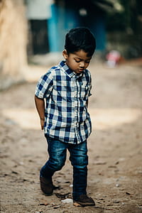 boy wearing blue and white plaid shirt and blue denim pants thumbnail