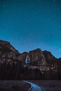 low-angle photo of waterfalls surrounded by mountains thumbnail