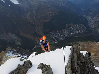 man hiking on peak thumbnail