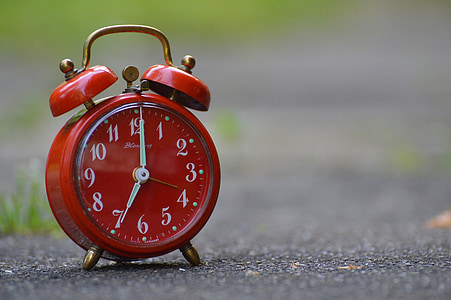 red alarm clock set on 7:00 thumbnail