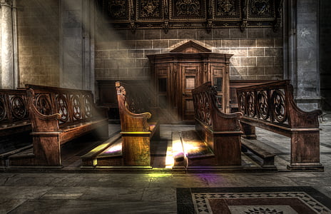 brown wooden pew with sun rays close-up photography thumbnail