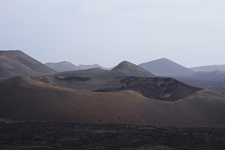 mountain range under cloudy sky thumbnail