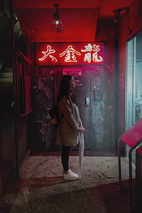 woman standing in front of store while holding an umbrella thumbnail