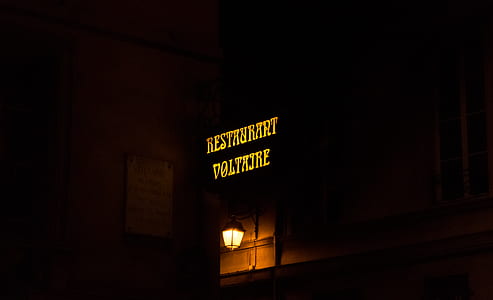 Restaurant Voltaire neon sign at night time thumbnail