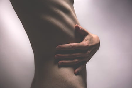 person top naked showing his side abdomen and his hand thumbnail