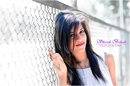woman beside cyclone fence thumbnail