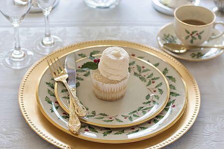 cupcake with three round ceramic plates and dinner knife and fork thumbnail