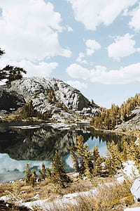 gray mountain near body of water thumbnail